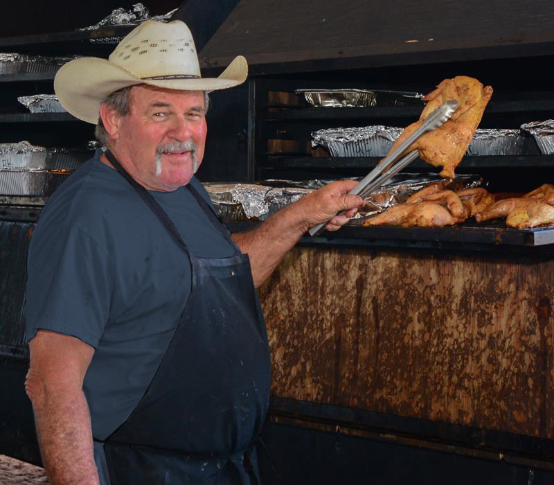 man cooking chicken